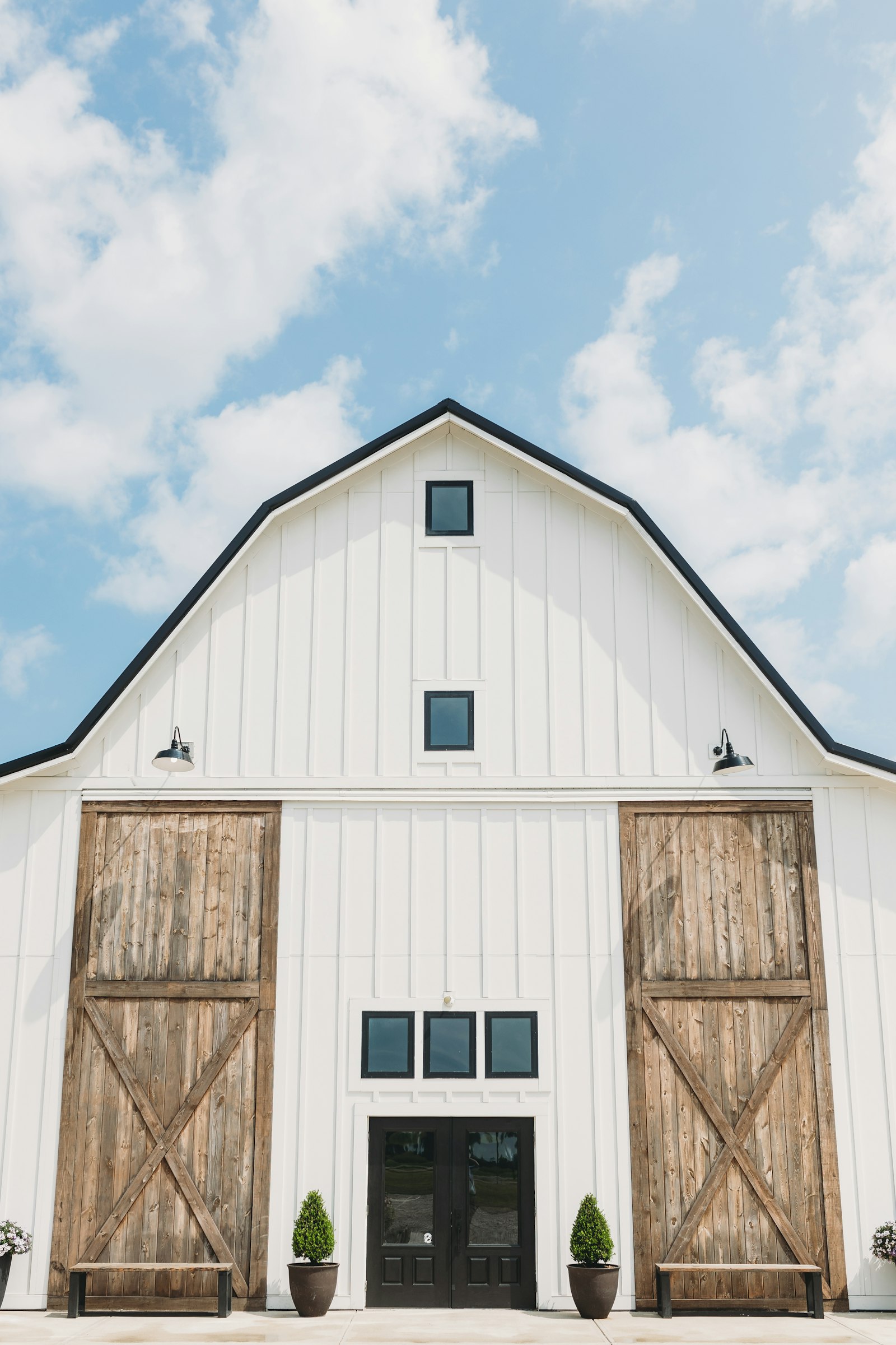 White barn wedding venue with large wooden doors