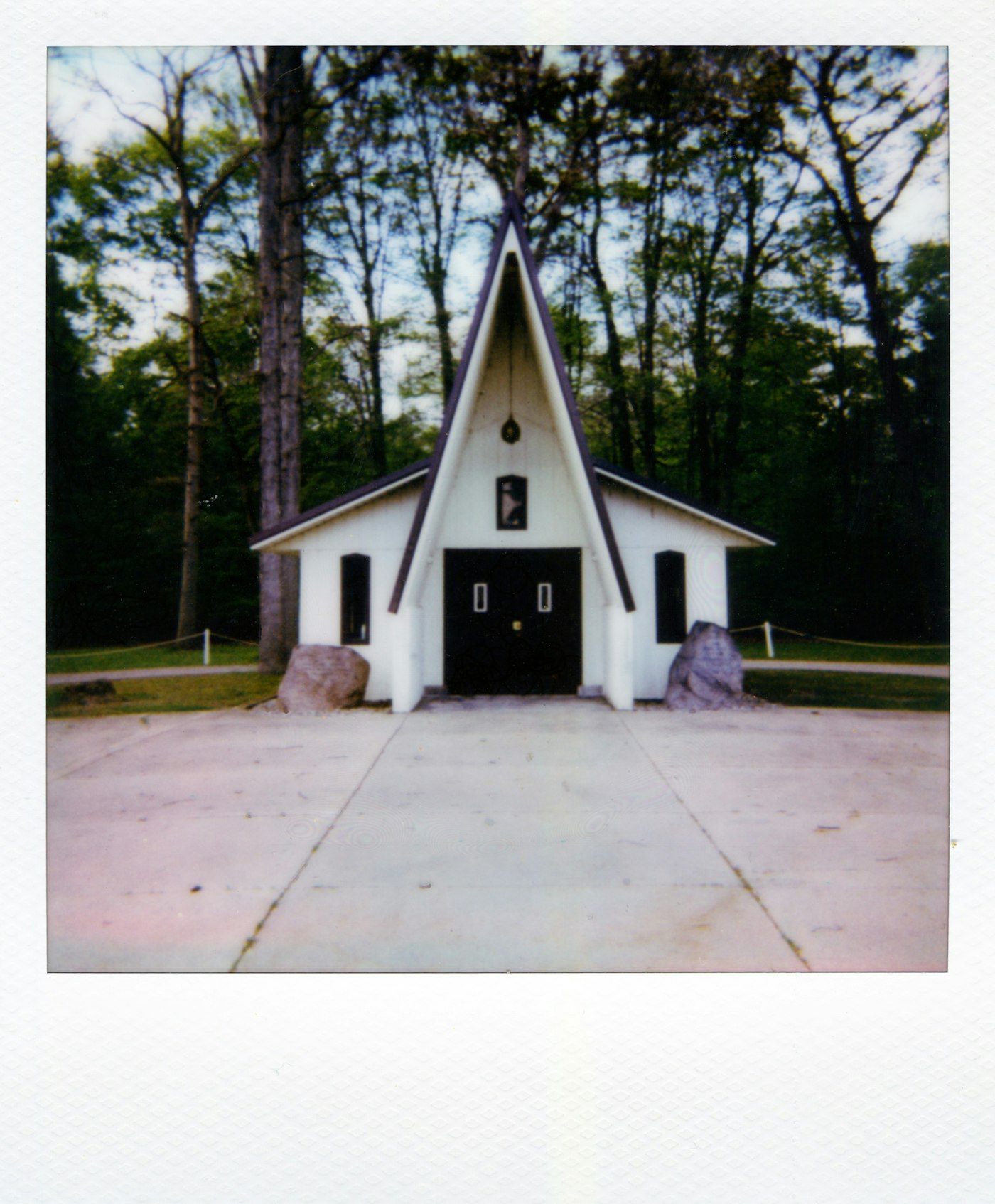 Small white chapel surrounded by trees